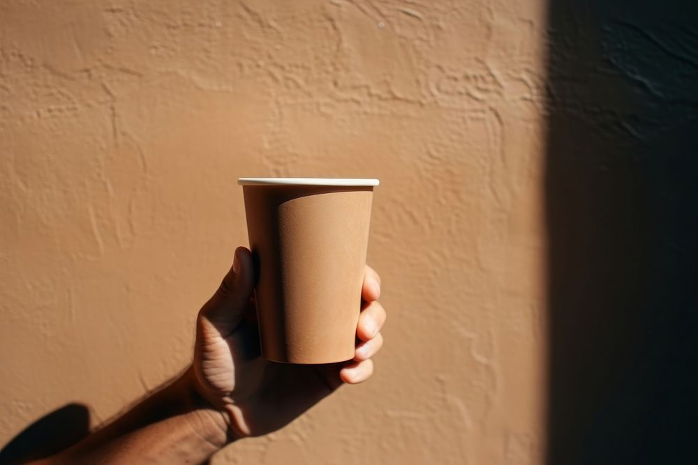 Man hand holding paper cup coffee beverage drink.