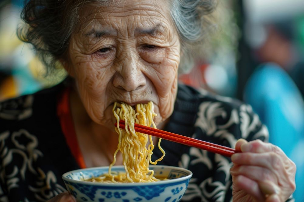 Mature woman eating chopsticks female.