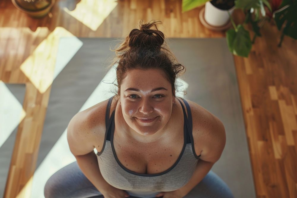 A happy chubby woman do yoga at home portrait adult photo.