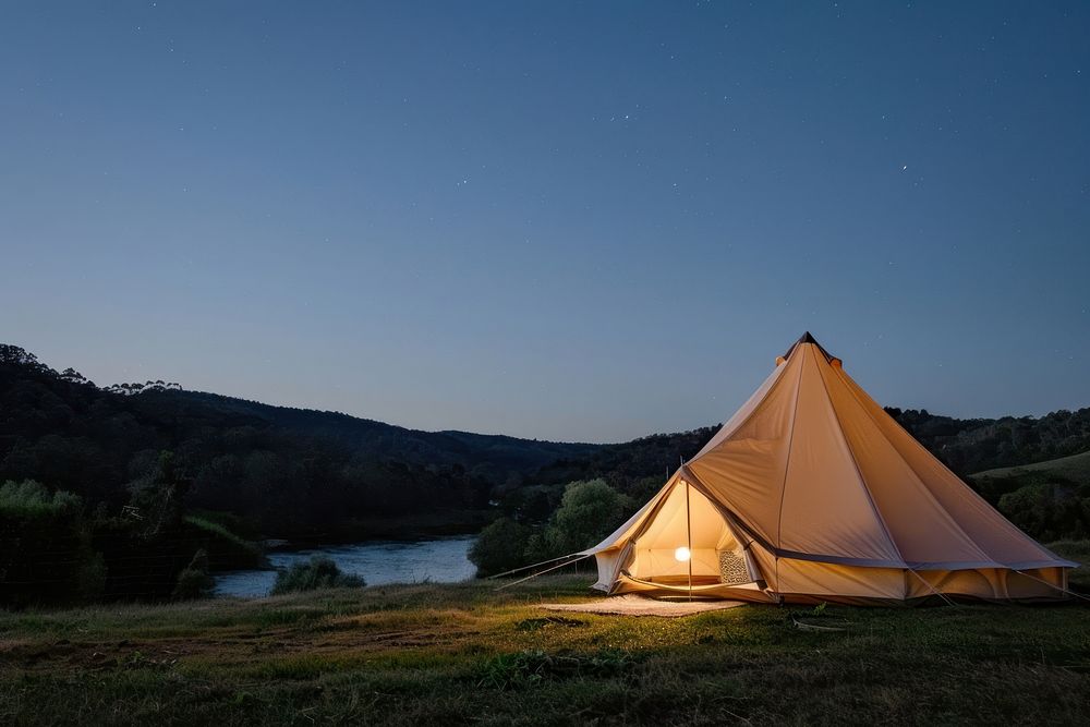A canvas bell tent at night sky outdoors camping nature.