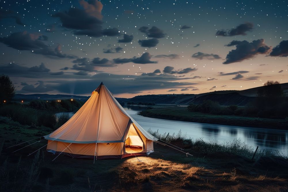 A canvas bell tent at night sky on land outdoors camping nature.