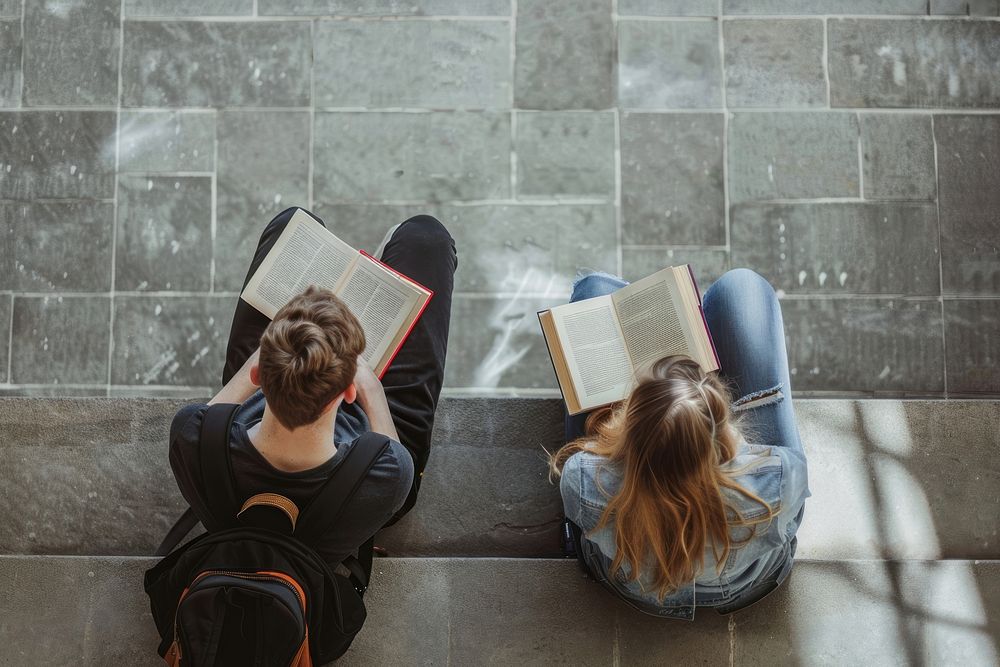 Male and female university students reading sitting adult.