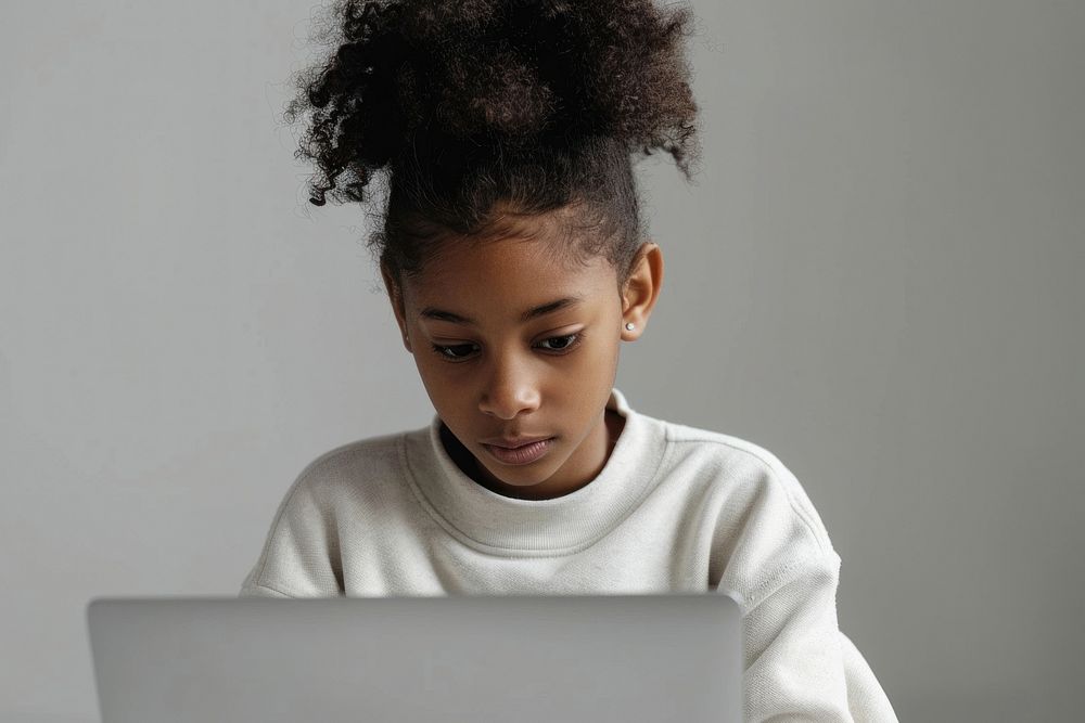 African american girl using laptop for online lesson computer child concentration.