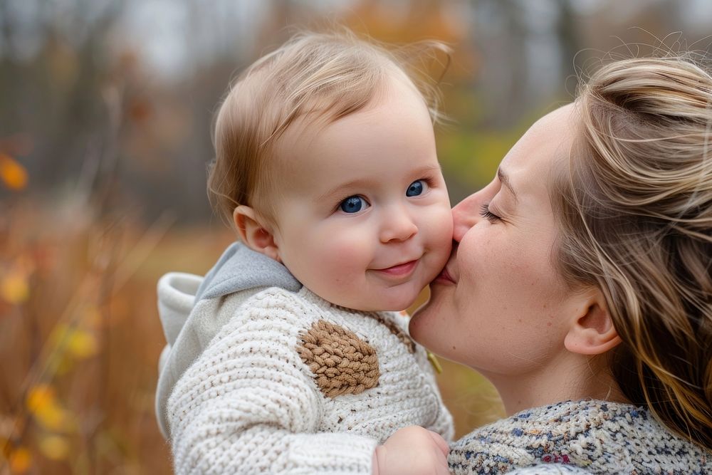 Happy mother kissing on cheek baby portrait photo affectionate.