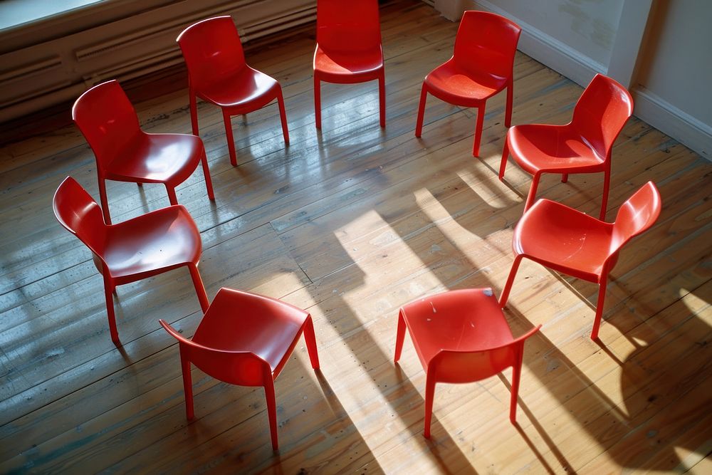 Circle of 8 red chairs on wooden floor furniture flooring hardwood.