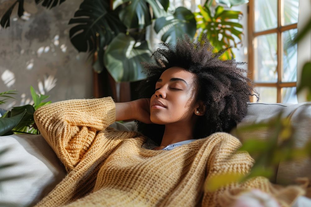 Young african american woman relax on the sofa clothing knitwear apparel.