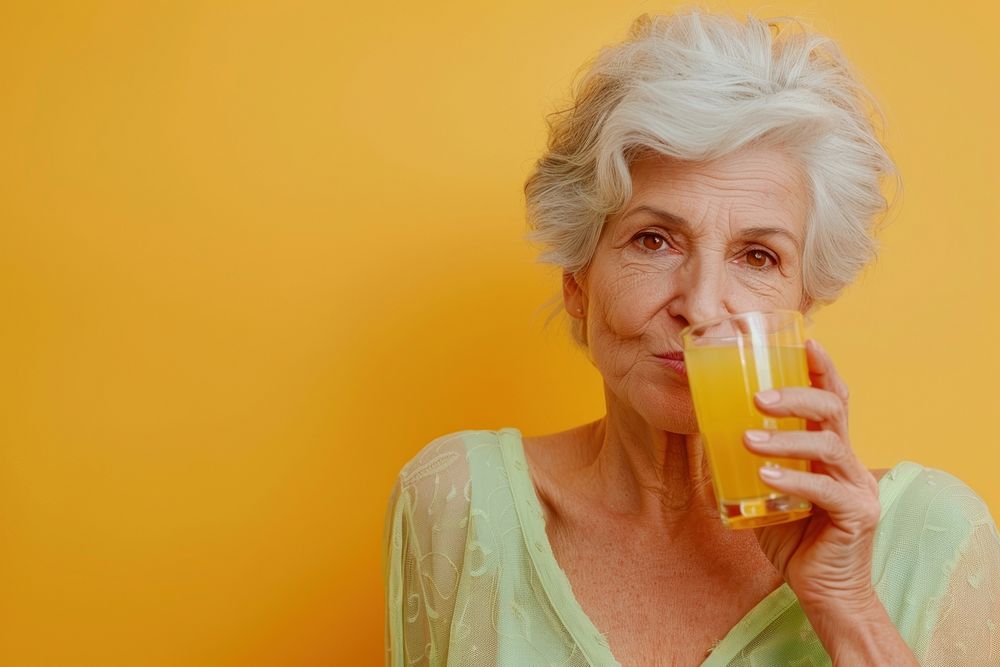 Mature woman drinking beverage alcohol.