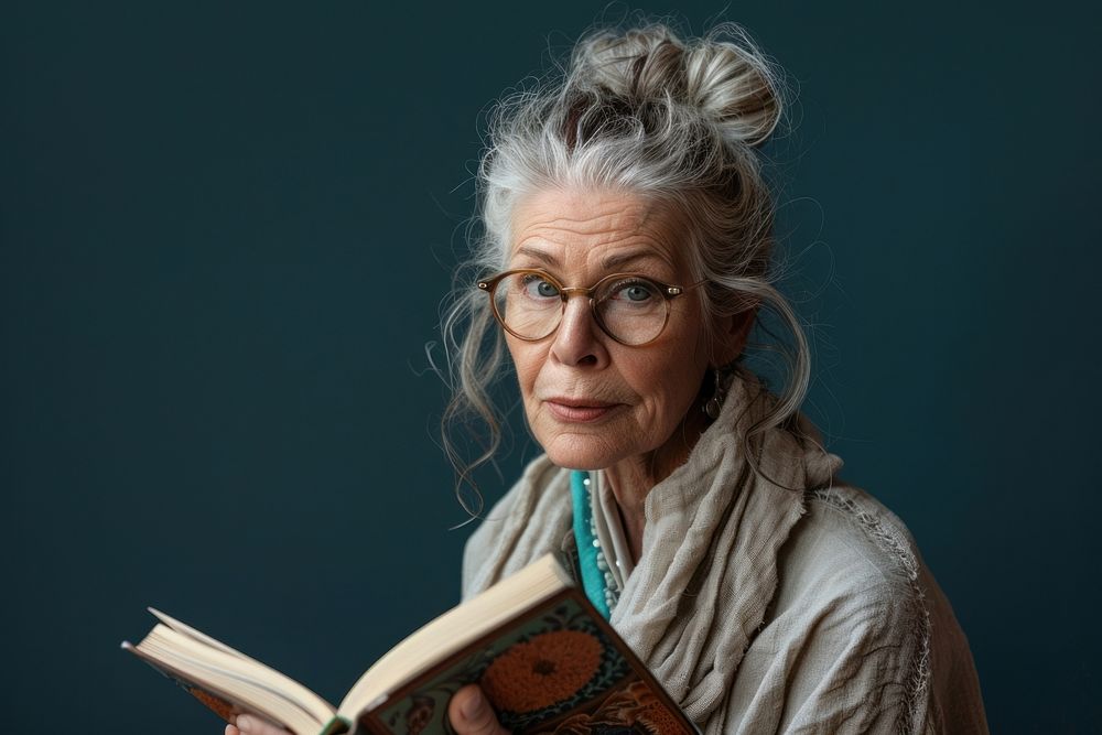 Mature woman reading photo book.