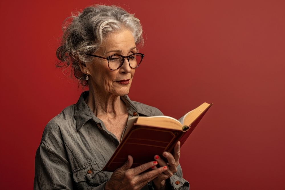 Mature woman reading book publication.