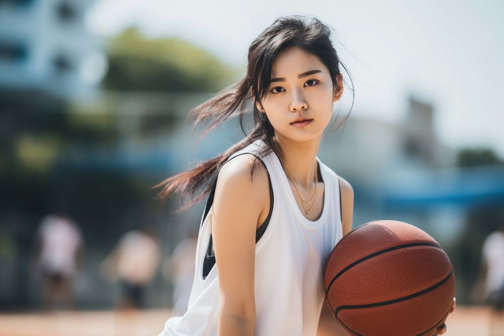 Sout east asian female athletic basketball playing basketball sports.