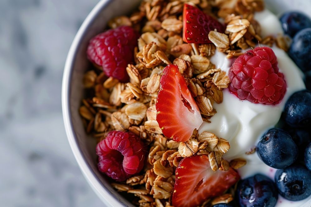 A bowl of almond buckwheat granola with yogurt and berries berry food strawberry.