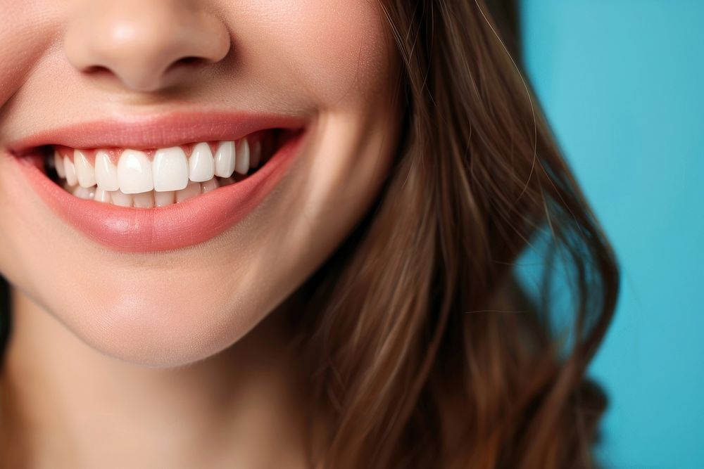 Women showing beautiful white smile teeth skin blue.
