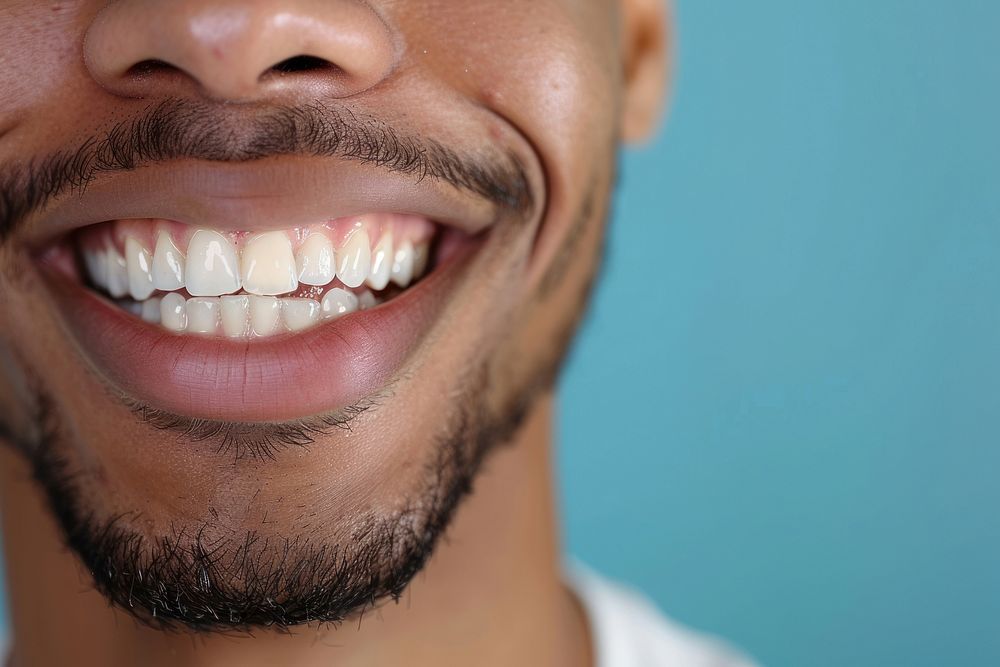 Man showing beautiful white smile teeth adult blue.