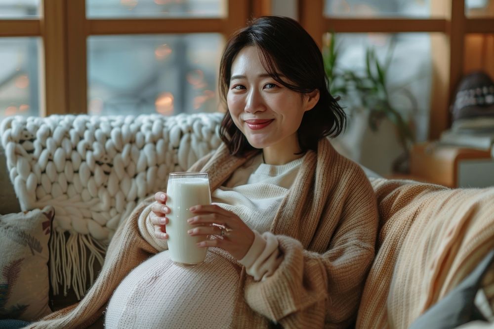Pregnant korean woman drink drinking blanket.