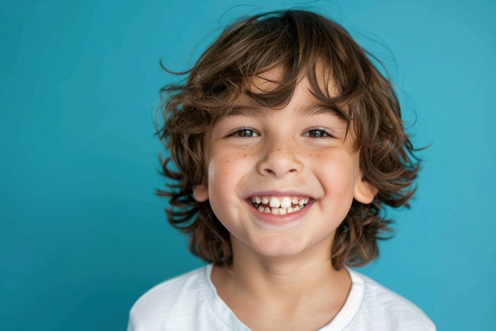 Half-body photo of a boy with broken tooth smiling child smile.