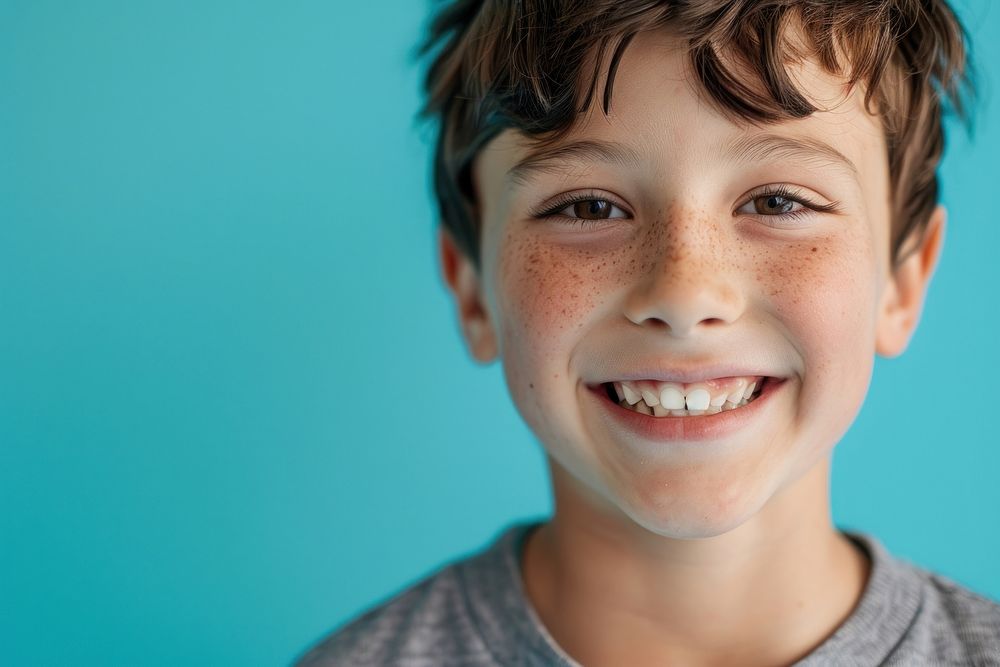 Half-body photo of a boy with broken tooth smiling smile happiness.