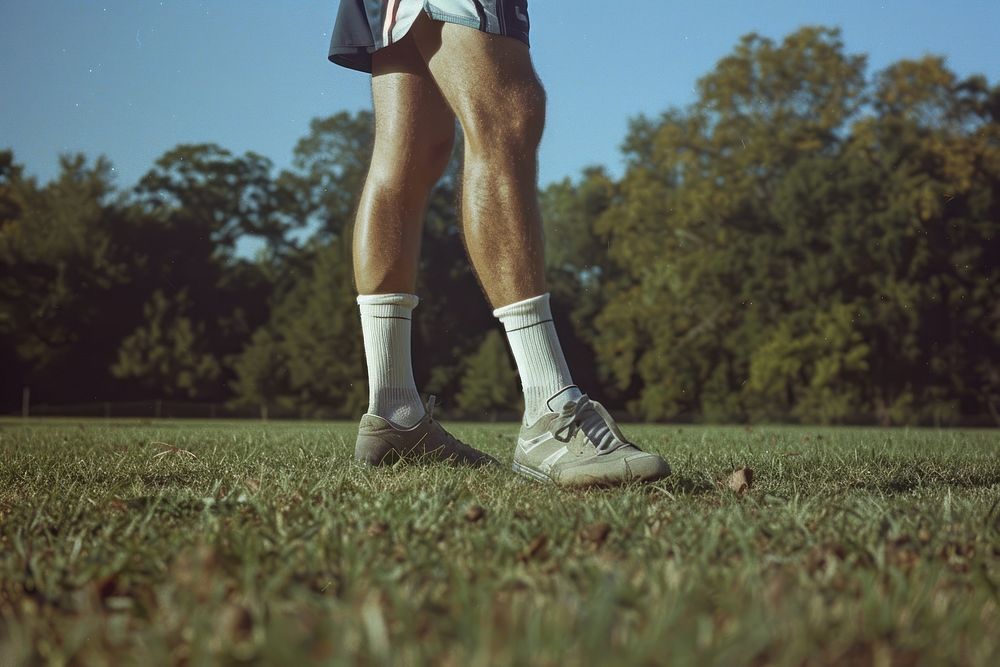 Soccer footwear standing grass.