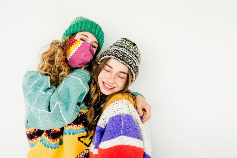 2 girls wear beanie sweater laughing portrait.