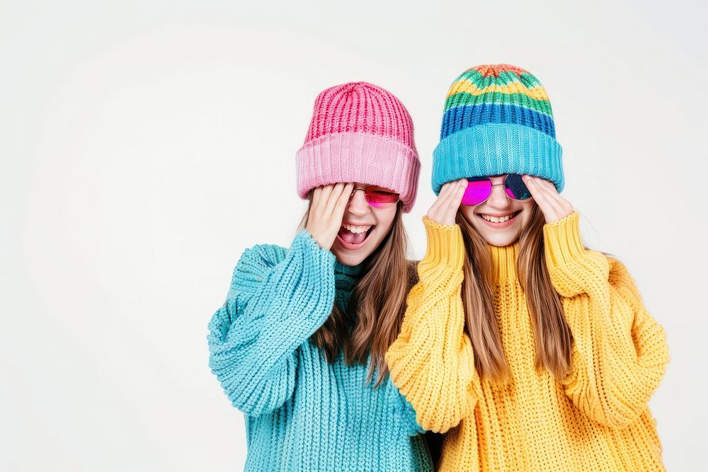 2 sisters wear beanie sweater smile laughing.