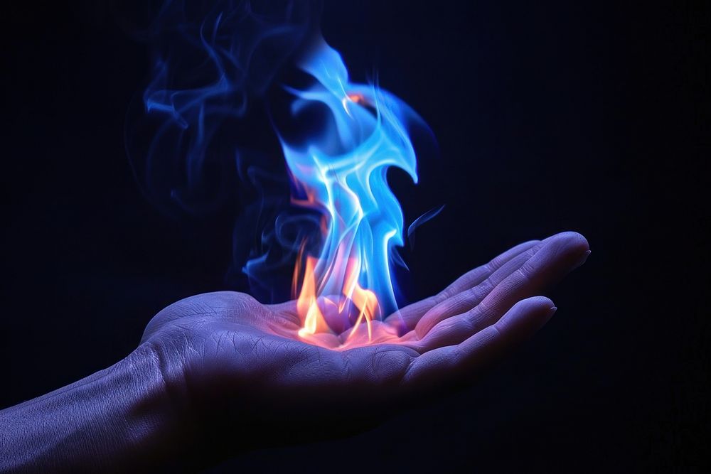 Hand fire flame adult smoke blue.