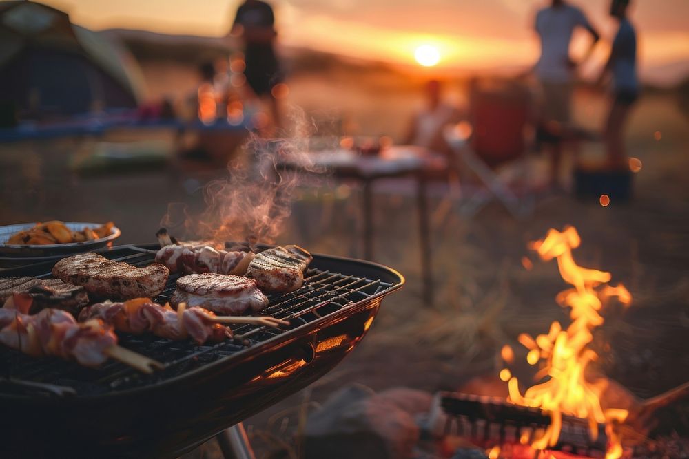 People party camping with BBQ grilling meat bbq cooking bonfire.