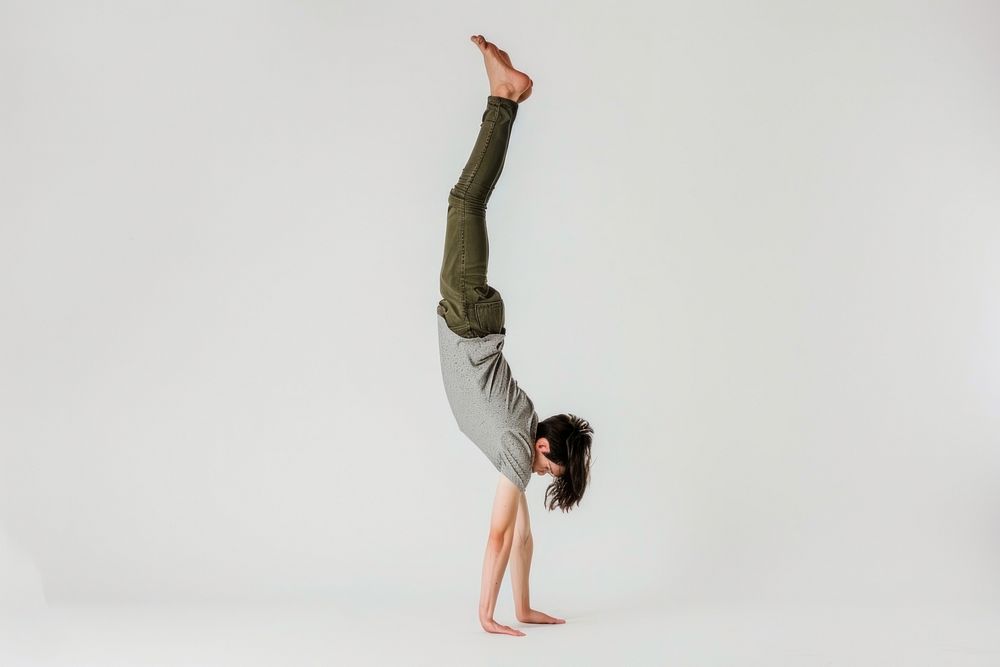 Teenage man handstand sports yoga white background.