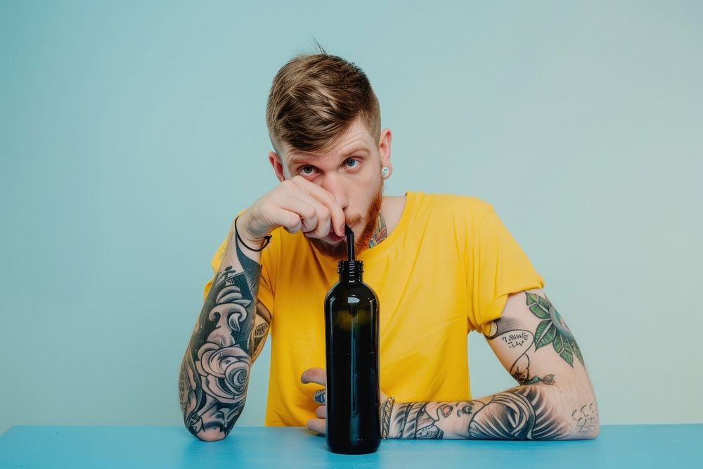 Teenage man straw bottle tattoo portrait drinking.