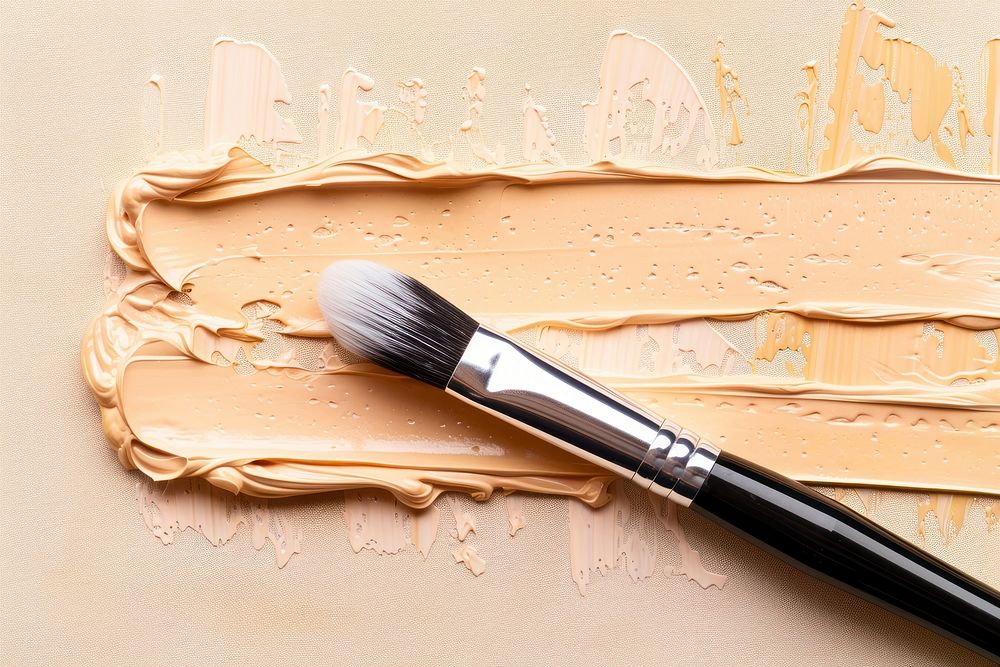 Close up on pale concealer cosmetics brush paint.