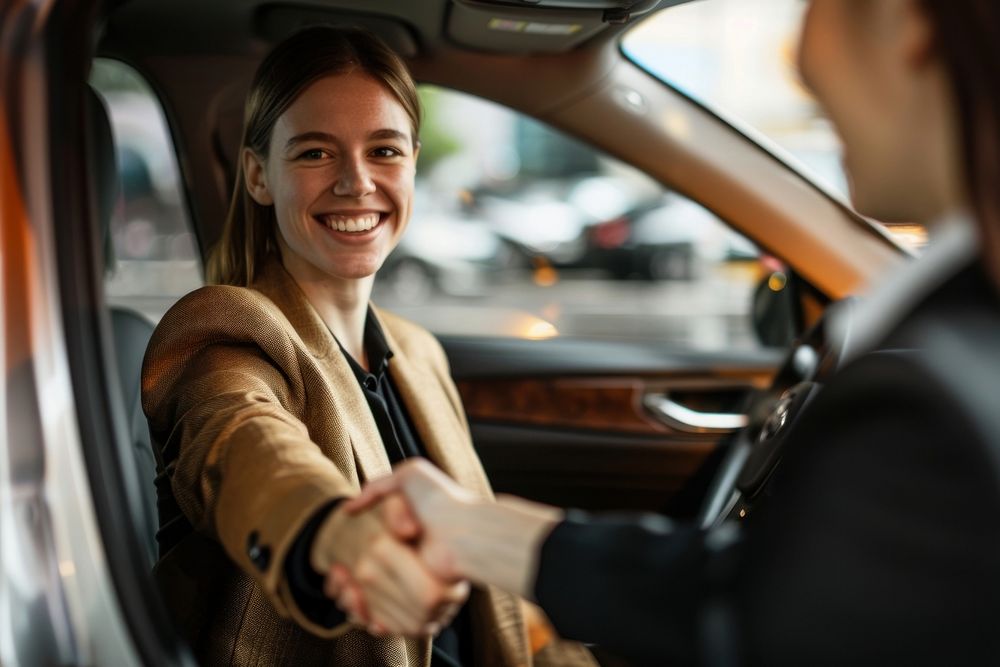 Businesswomen making handshake with partner in car vehicle driving adult.