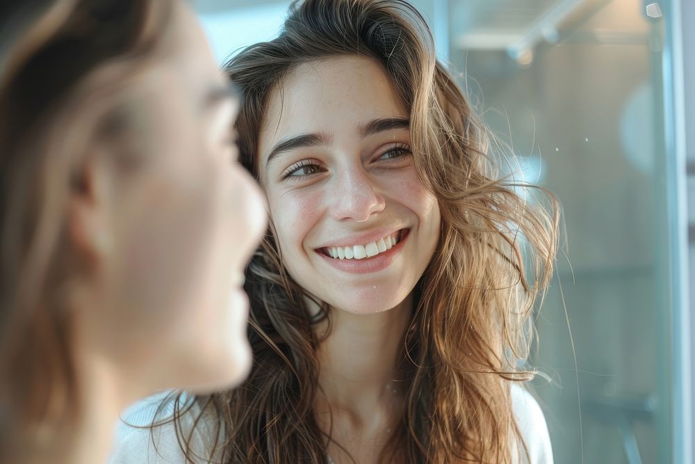 Smiling girl look in mirror smiling adult smile.