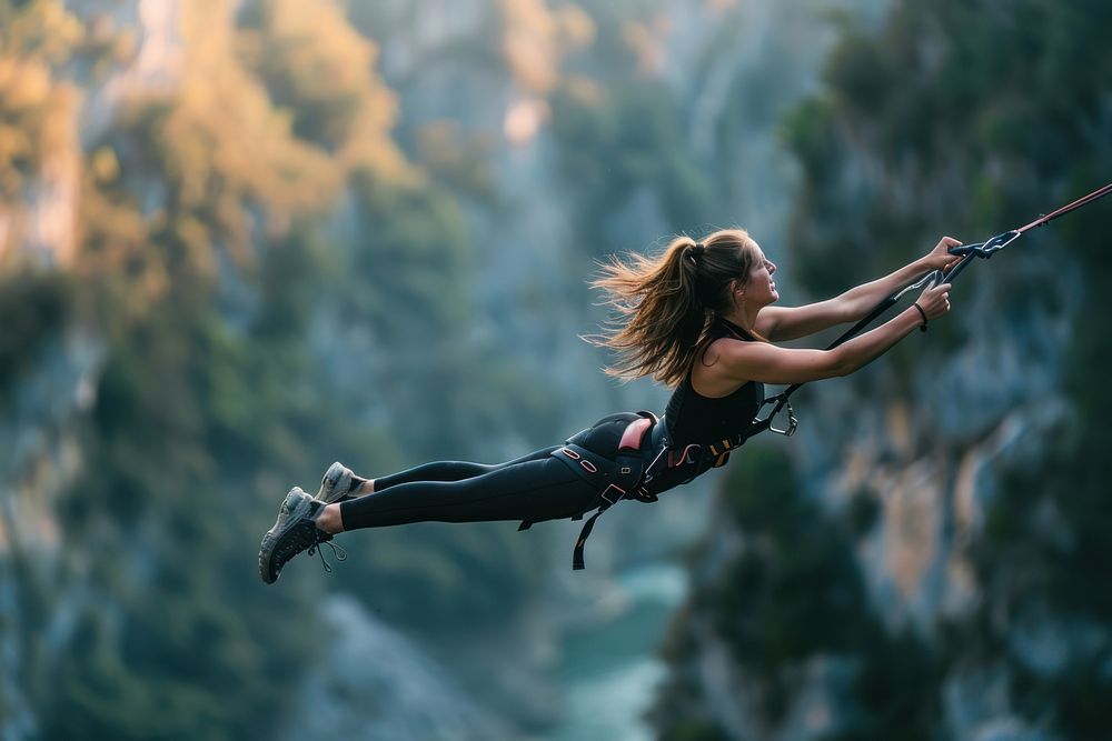 Woman in bungee jumping recreation adventure outdoors.