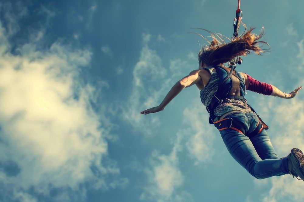 Woman in bungee jumping adventure outdoors exhilaration.