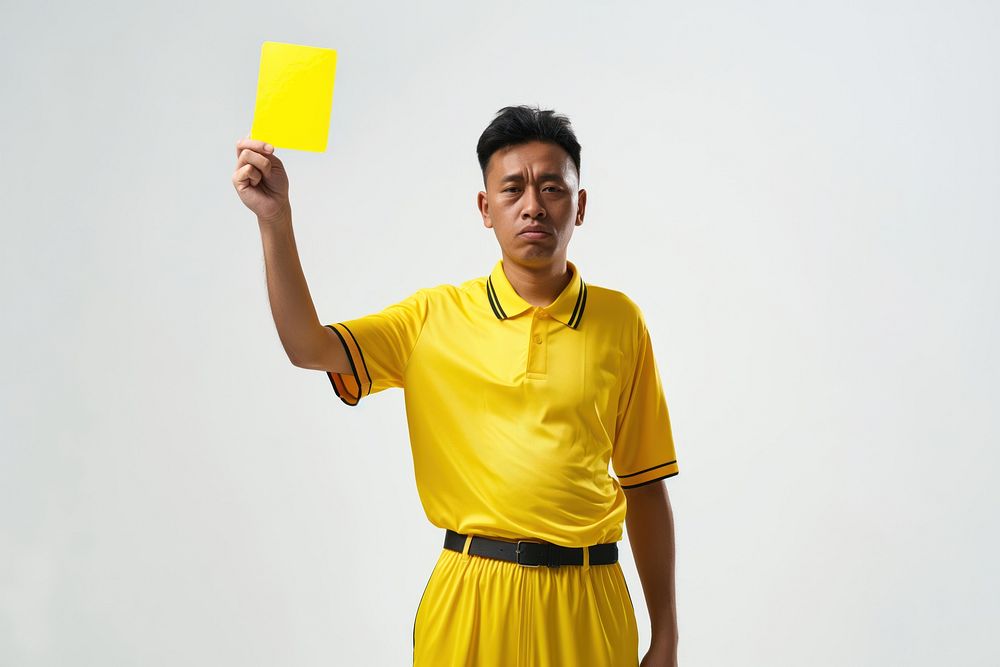 Photo of a referee showing a yellow card while holding it upwards portrait adult photo.
