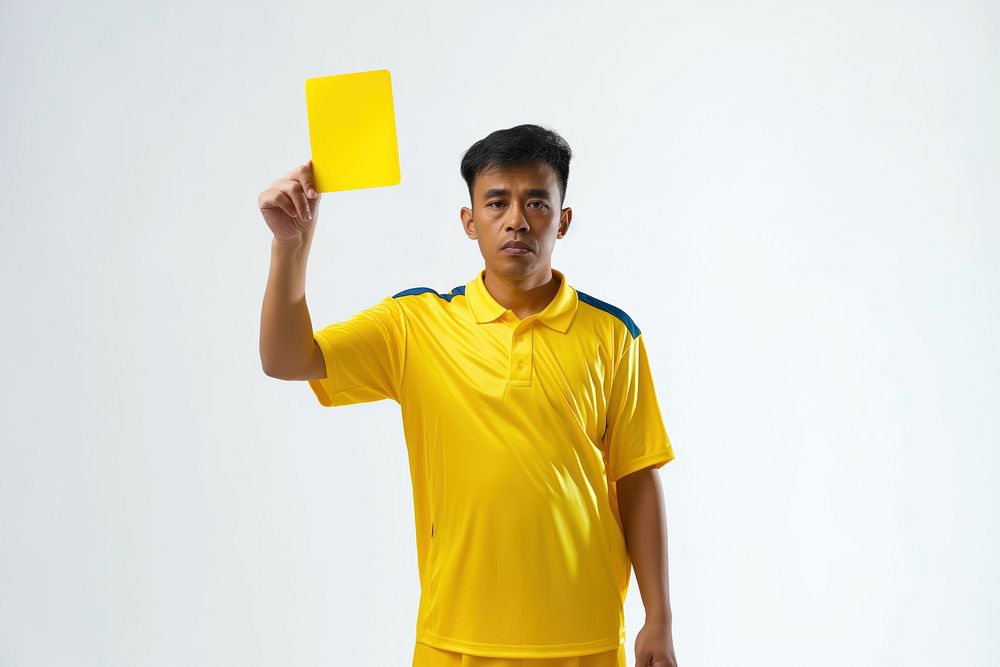Photo of a referee showing a yellow card while holding it upwards adult white background competition.