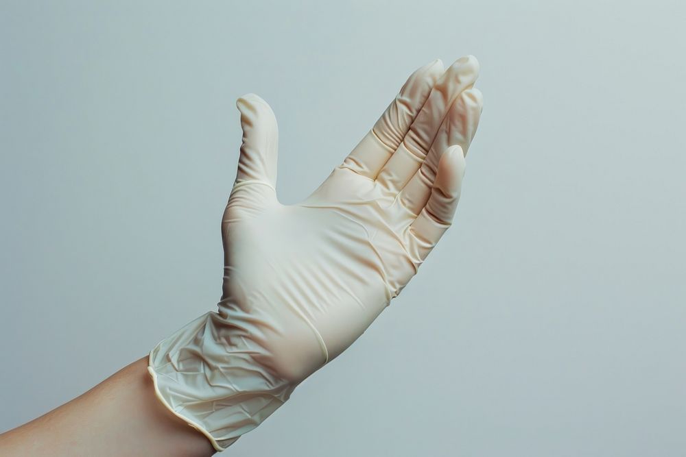 Hand wearing a glove adult clothing apparel.