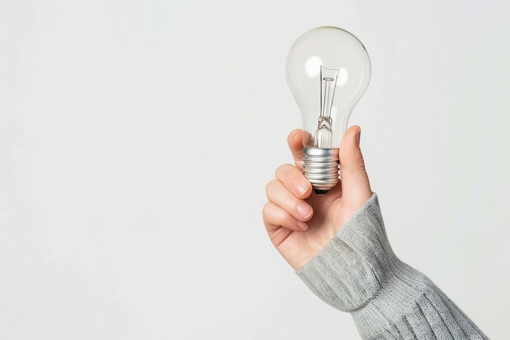 Photo of person holding light bulb lightbulb electricity innovation.