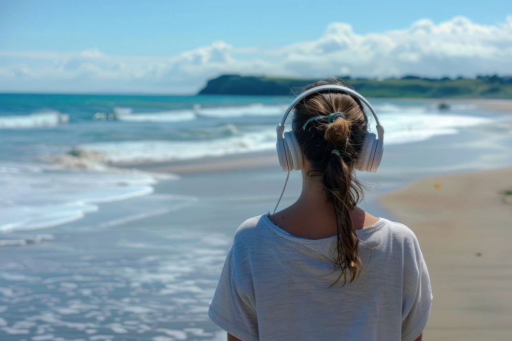 Woman Listens To Music beach headphones outdoors.