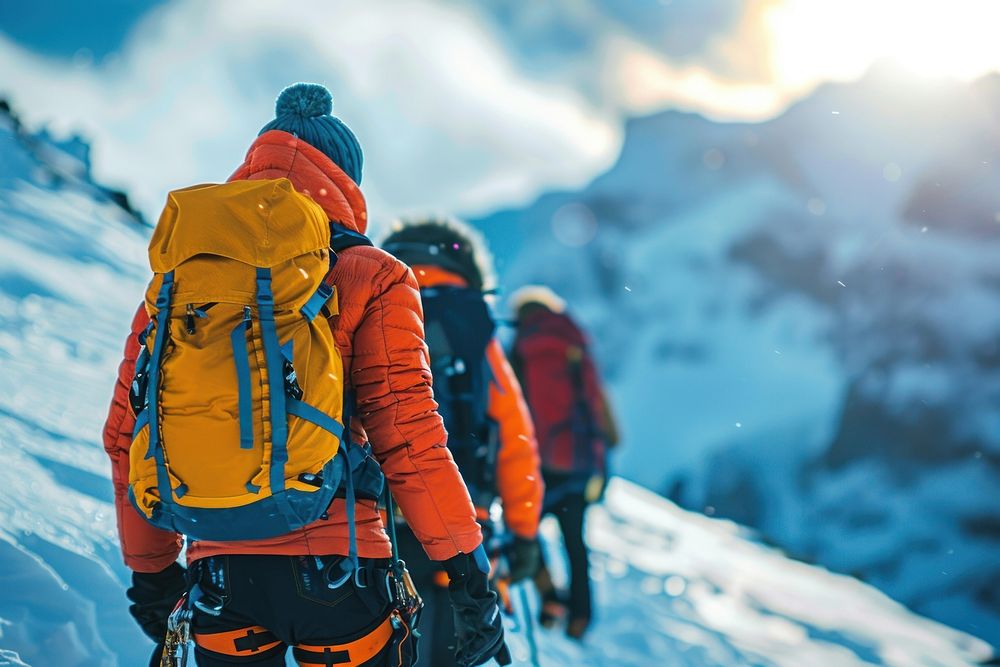 Climbing guide leads two clients outdoors backpacking baggage.