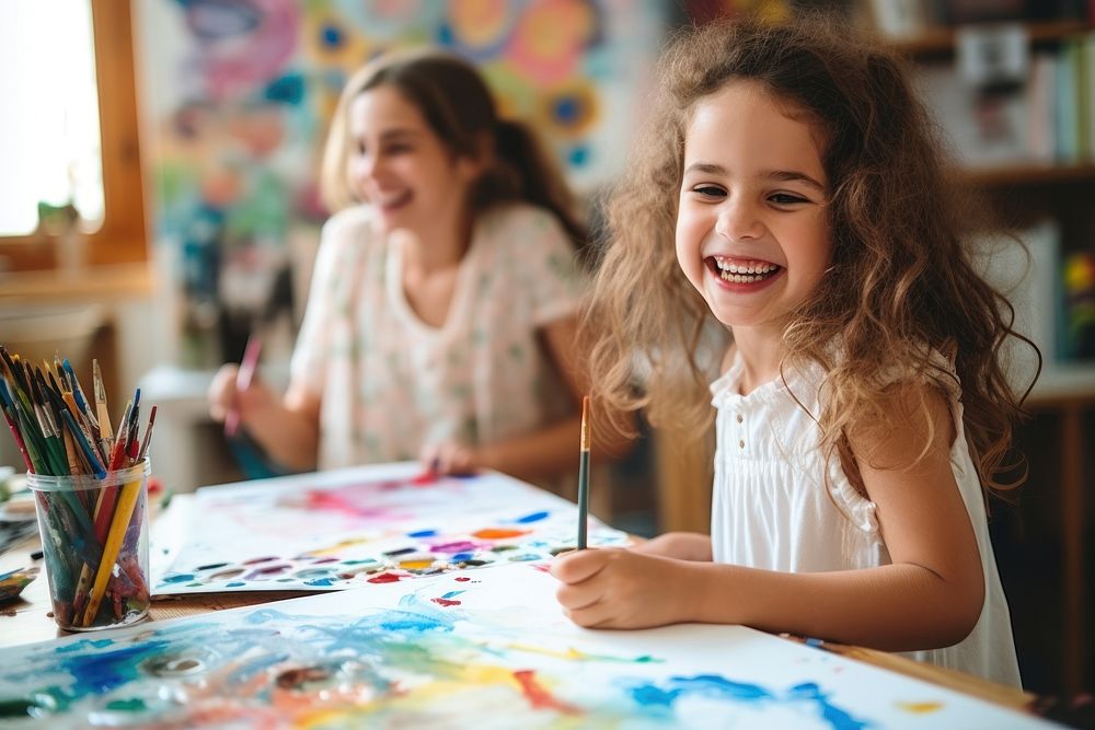Girl painting with colorful gouache happy laughing person.
