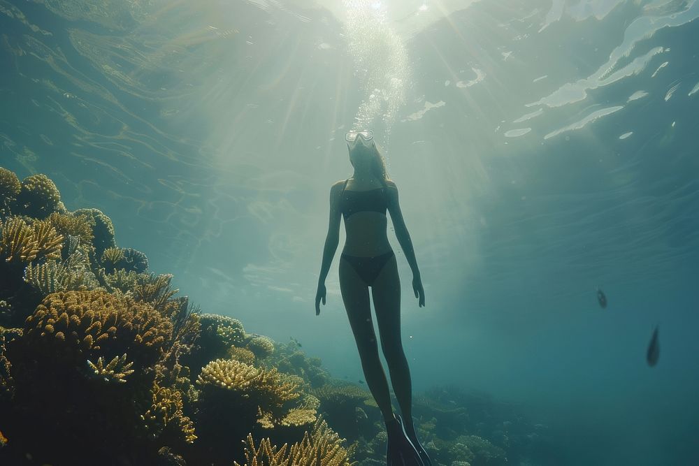 Free diver girl underwater outdoors sea.