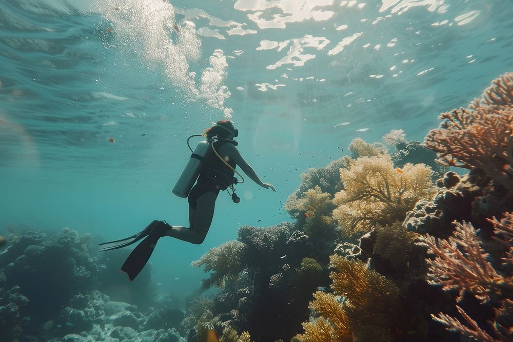 Scuba diver girl underwater outdoors sea.