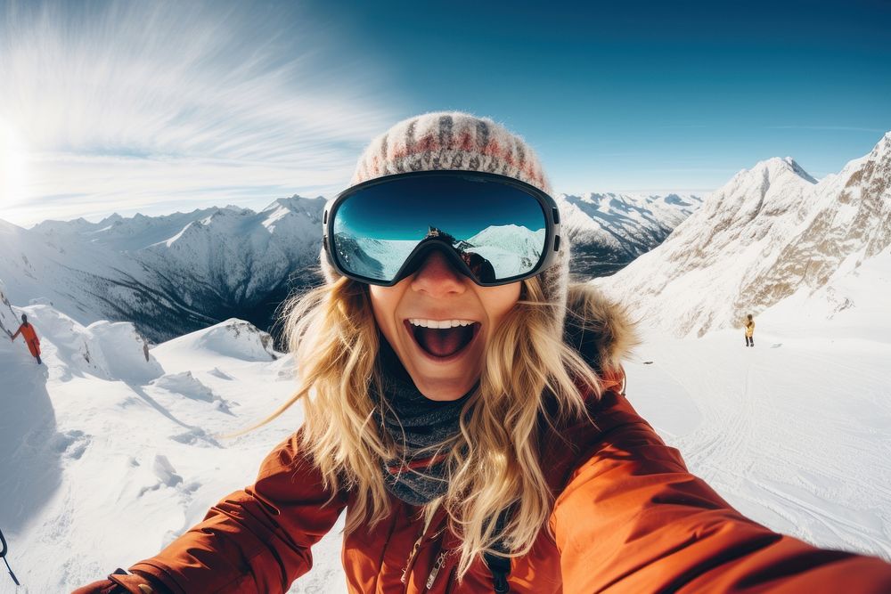 Snowboarder mountain selfie sunglasses.