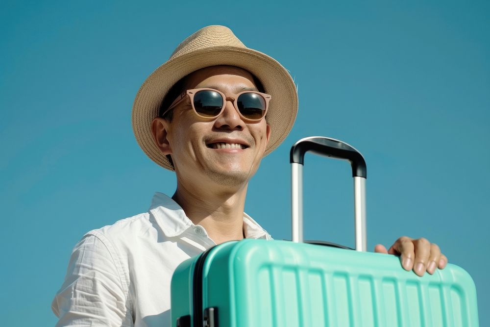 Happy Singaporean man going on holiday trip happy baggage luggage.