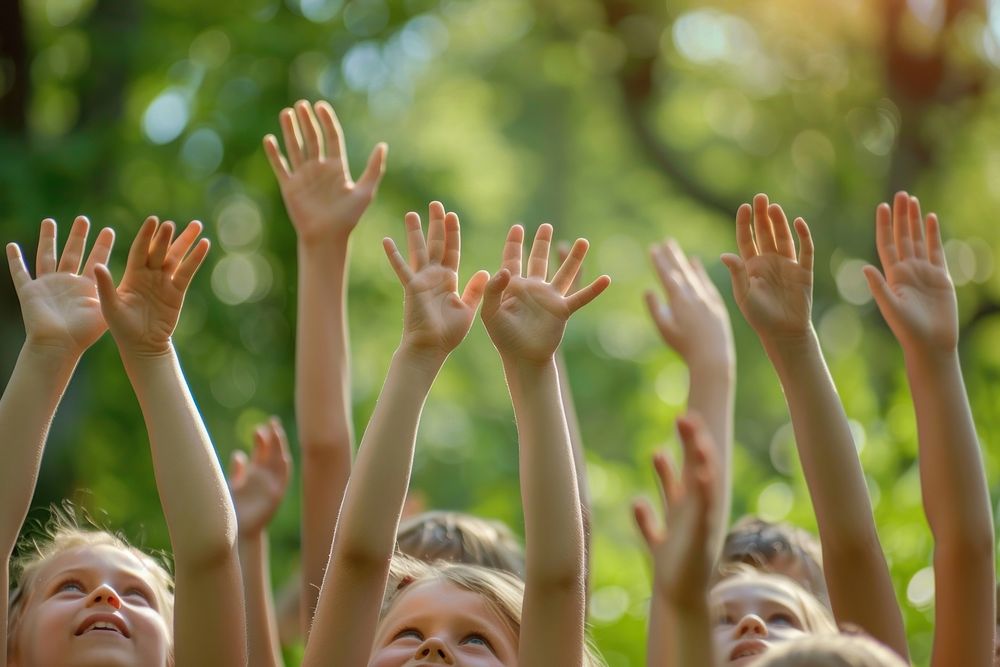 Kids raising hands up celebrating concert finger.