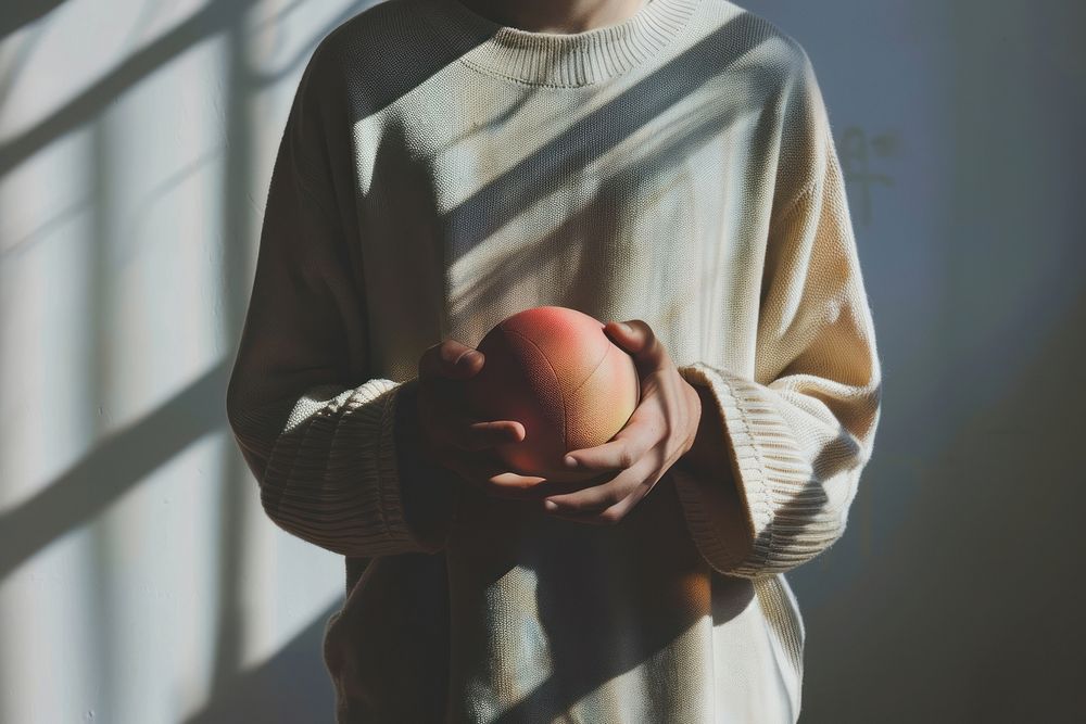 Person holding ball produce sports apple.
