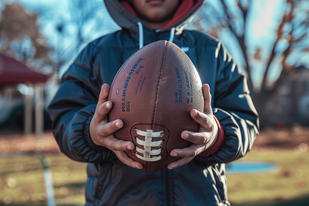 Person holding football sports human playing american football.