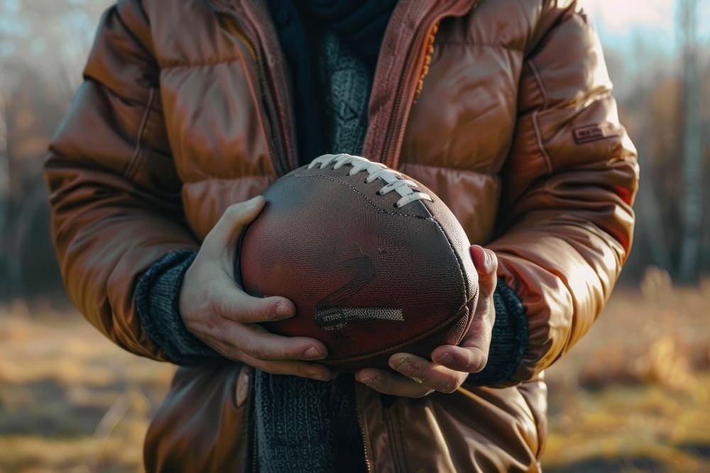 Person holding football clothing apparel soccer.