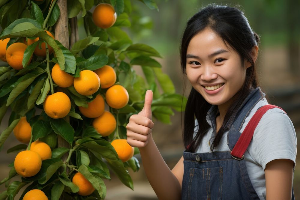 Thai girl farmer orange grapefruit produce.