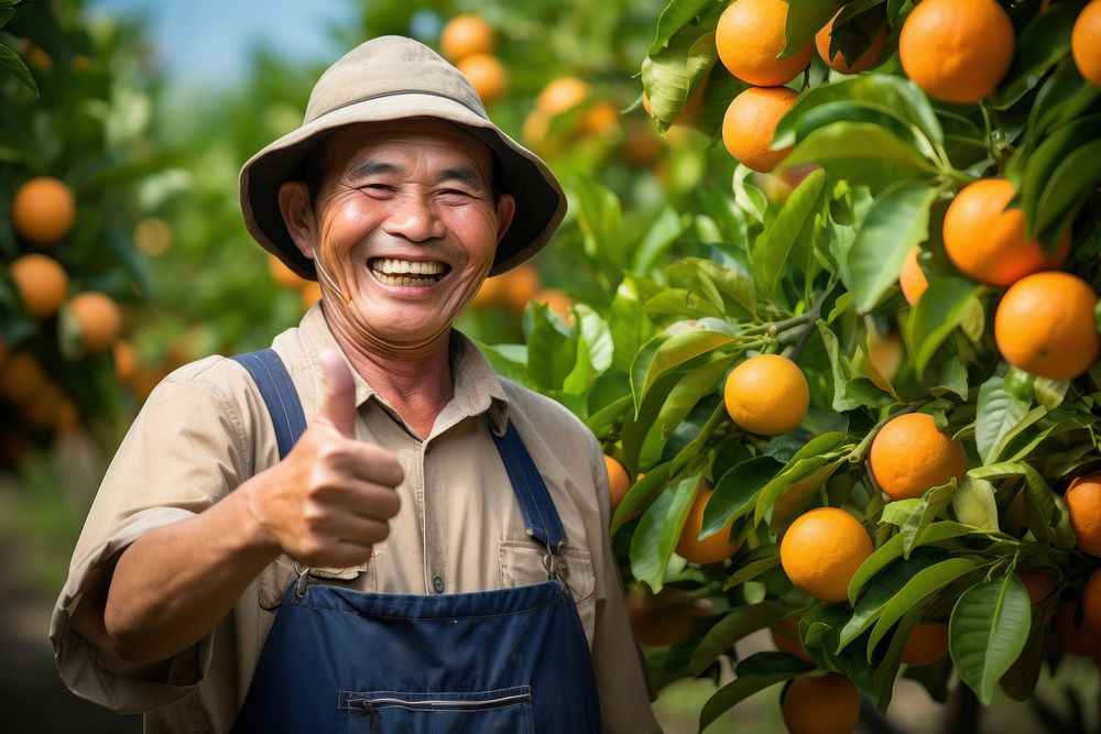 Thai farmer orange clothing laughing.