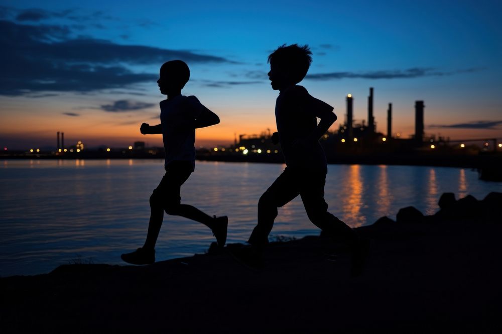 Kids running silhouette photography backlighting sunset architecture.